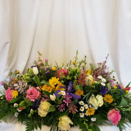 Large mixed bouquet with roses, tulips, and daisies in pink, yellow, purple, and white