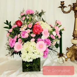 Pink and white floral arrangement in a square glass vase