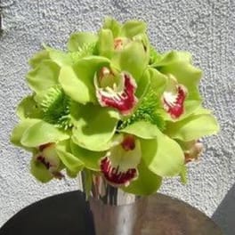 Green orchid bouquet in a silver vase