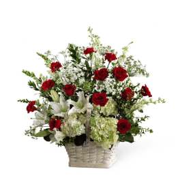Basket arrangement of red roses and white lilies