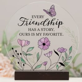 Round friendship plaque with purple flowers and a butterfly on a wooden base
