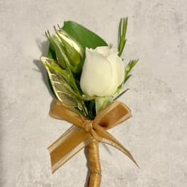 White rose boutonniere with gold ribbon bow on a light background