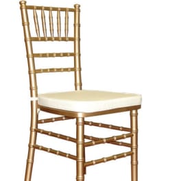 Gold Chiavari chair with a cream seat cushion