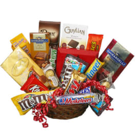 Basket of assorted candy bars and chocolates with red ribbon