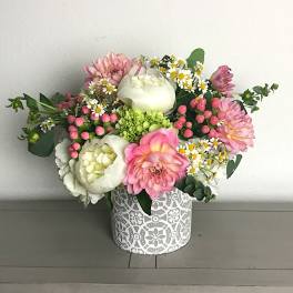 Pink and white mixed bouquet in a patterned round box