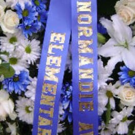 White and blue funeral wreath with a purple ribbon
