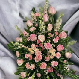 Pink roses and carnations arranged in a cascading spray