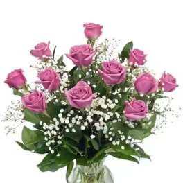 Pink roses in a glass vase with white baby's breath
