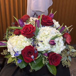 Bouquet of red roses, white hydrangeas, and purple tulips