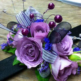 Lavender rose bouquet with purple accents and ribbon loops