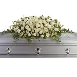 White floral casket spray with roses and calla lilies