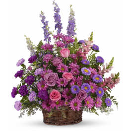 Basket arrangement of pink and purple flowers with tall lavender spikes