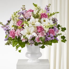 Pink and white mixed flower arrangement in a white vase