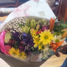 Mixed bouquet of colorful flowers wrapped in paper