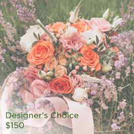 Pink and orange rose bouquet with lavender filler flowers and a ribbon