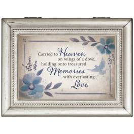 Framed memorial sign with blue flowers and the words "Carried to Heaven"