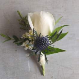 White rose boutonniere with thistle