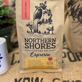 Bag of Northern Shores Coffee Co. espresso beans on a burlap surface