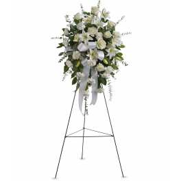 White floral standing spray on a black easel with ribbon streamers