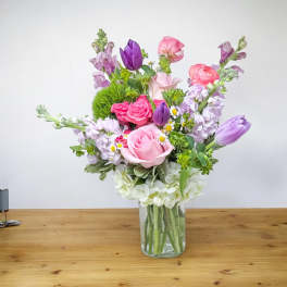 Mixed pink and purple bouquet in a clear glass vase