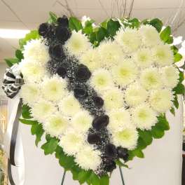 Heart-shaped white chrysanthemum wreath with black roses and ribbon