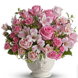 Pink roses and alstroemeria arranged in a white vase
