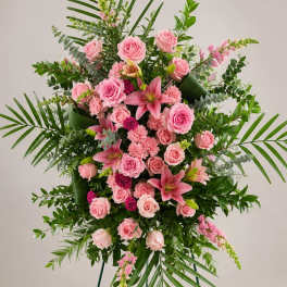 Large standing floral spray with pink roses and lilies on a tripod easel