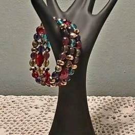 Beaded multicolor bracelet on a black hand display stand