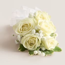 Bouquet of pale yellow roses with white filler flowers and a sheer ribbon