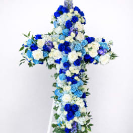 Blue and white floral cross on a white stand