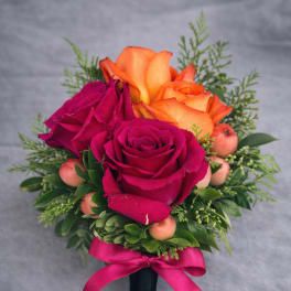 Hand-tied bouquet of pink and orange roses with a ribbon wrap