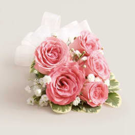 Pink rose bouquet with white filler flowers and a white ribbon bow