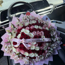 Large bouquet of red, pink, and white roses with pale alstroemeria