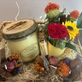 Gift basket with a candle, matches, and a small flower arrangement
