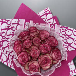 Bouquet of pink roses wrapped in bright pink paper