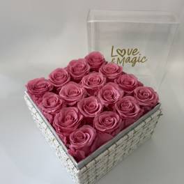 Pink roses arranged in a square gift box with a clear lid