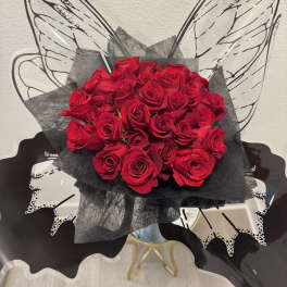 Bouquet of red roses wrapped in black paper