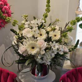 White and blush floral arrangement in a silver vase