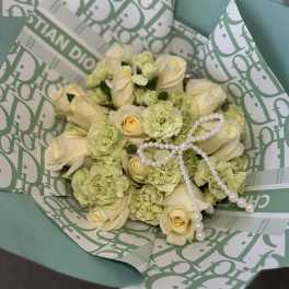 Cream roses and pale green carnations in teal wrapping with pearl strands