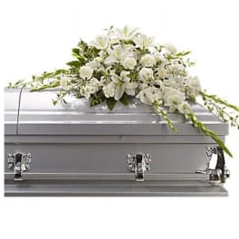 White floral spray on a silver casket
