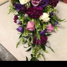 Cascade bouquet of pink, purple, and white flowers