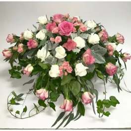 Pink and white rose bouquet with trailing greenery