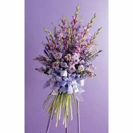 Tall lavender bouquet with roses and mixed purple flowers tied with ribbons