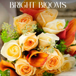 Bouquet of peach and cream roses with orange calla lilies