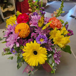Bright mixed bouquet with gerbera daisies, chrysanthemums, and a butterfly pick
