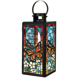 Decorative black lantern with stained-glass butterfly and flower panels