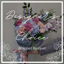 Wrapped bouquet of pastel roses and hydrangeas with lavender flowers