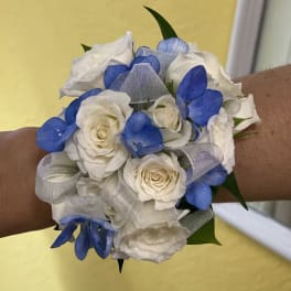 White and blue rose wrist corsage with silver ribbon