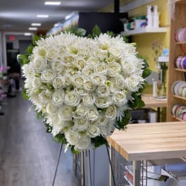 Large white rose and chrysanthemum standing spray on an easel