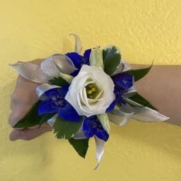 White and blue wrist corsage with silver ribbon